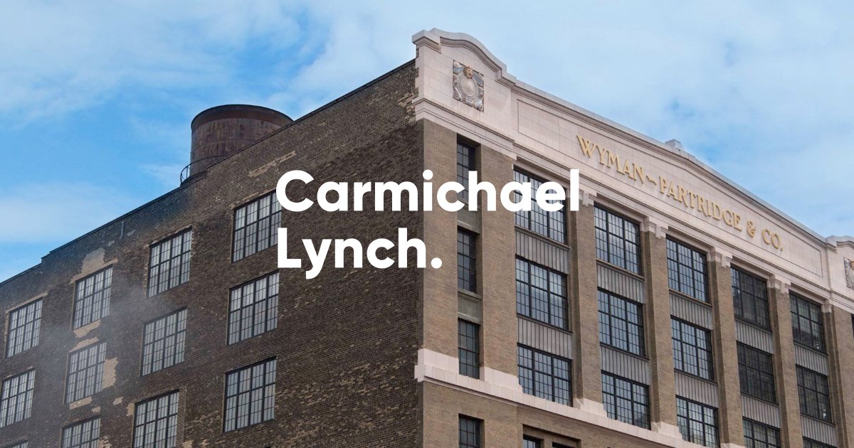 A photograph of the Wyman-Partridge and Co building in Minneapolis, Minnesota. The Carmichael Lynch logo is overlaying the photograph.